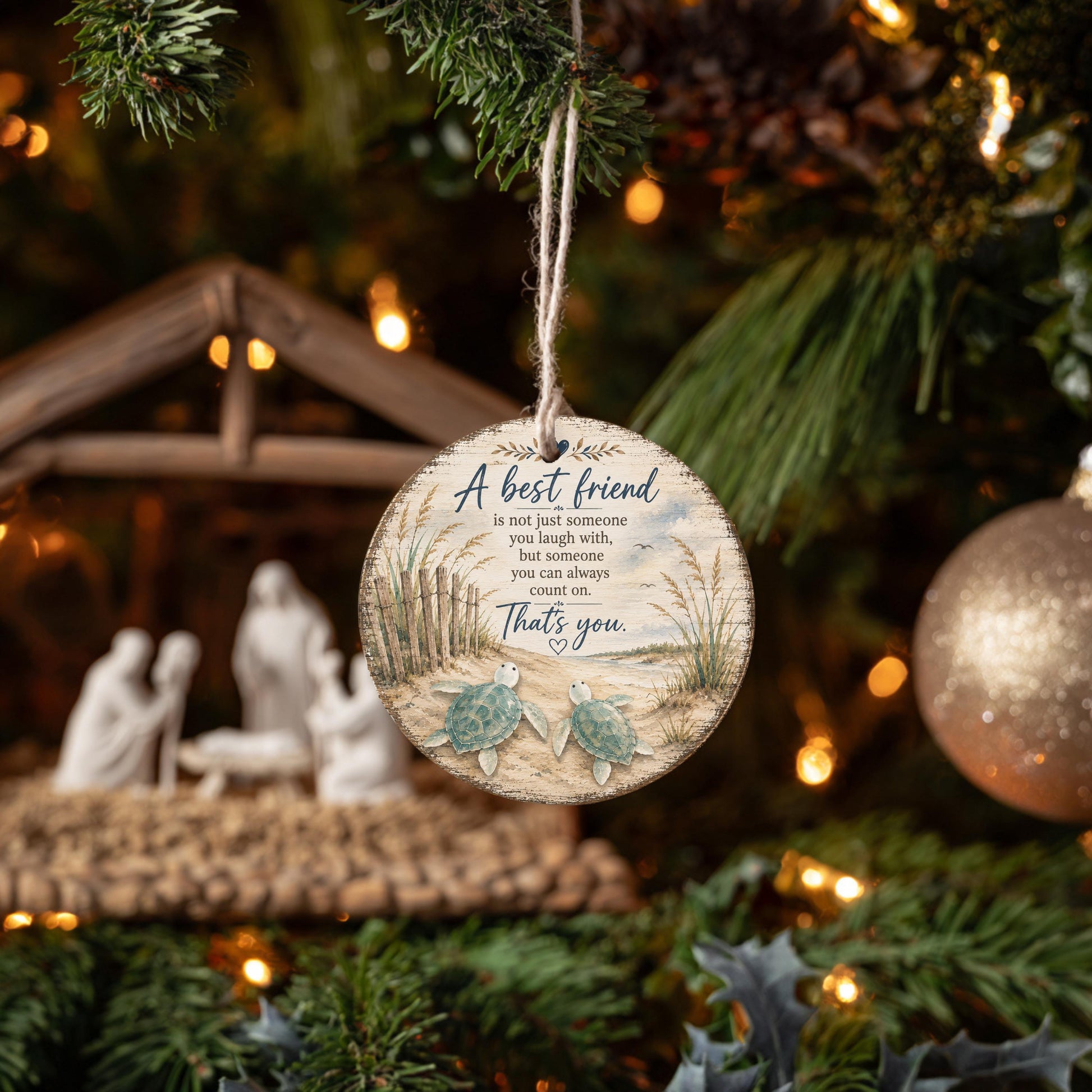 A round ornament hanging from a Christmas tree, featuring a message about being a best friend.