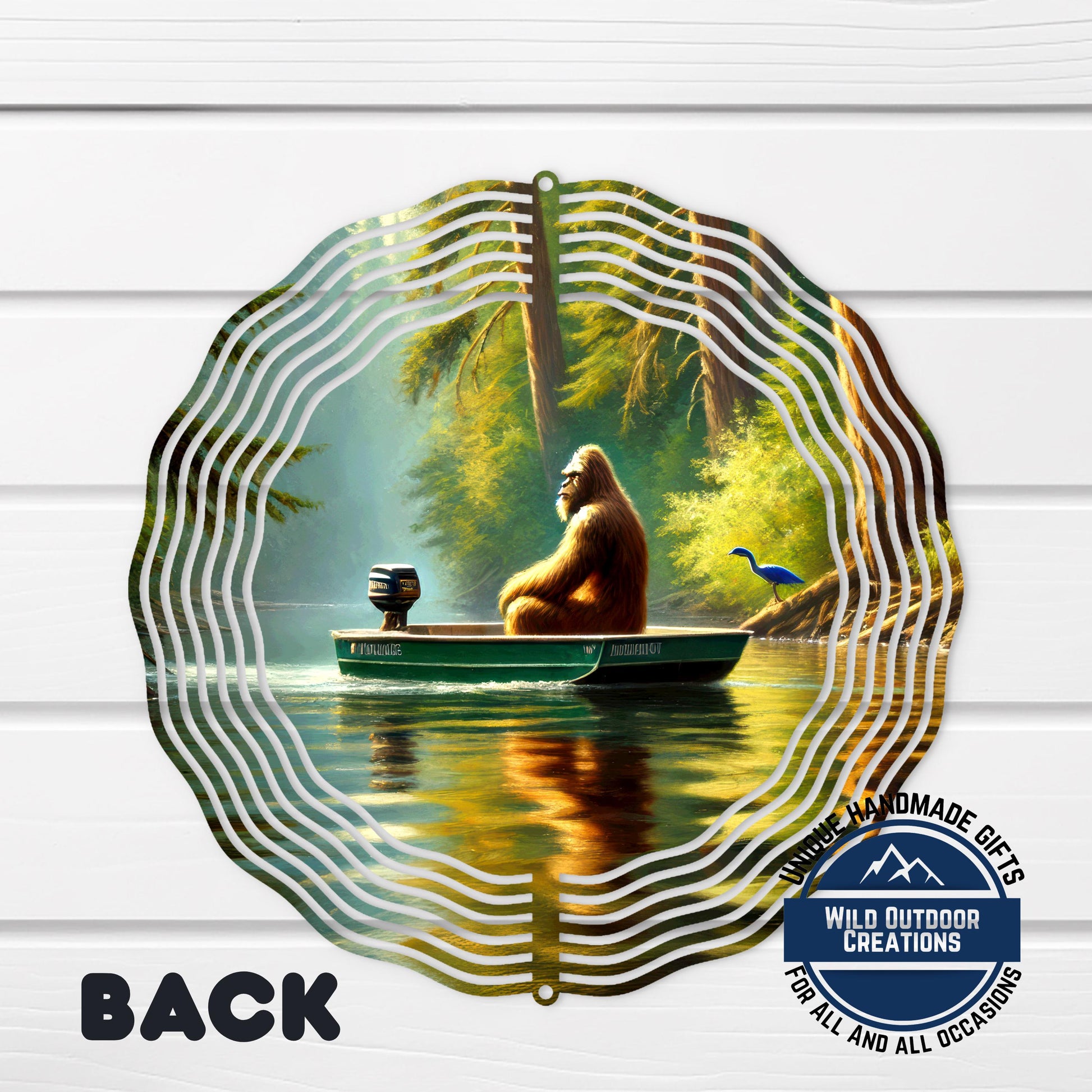 A large metal wind chime with a painting of an orangutan sitting in a boat on a river, surrounded by trees and a bird.