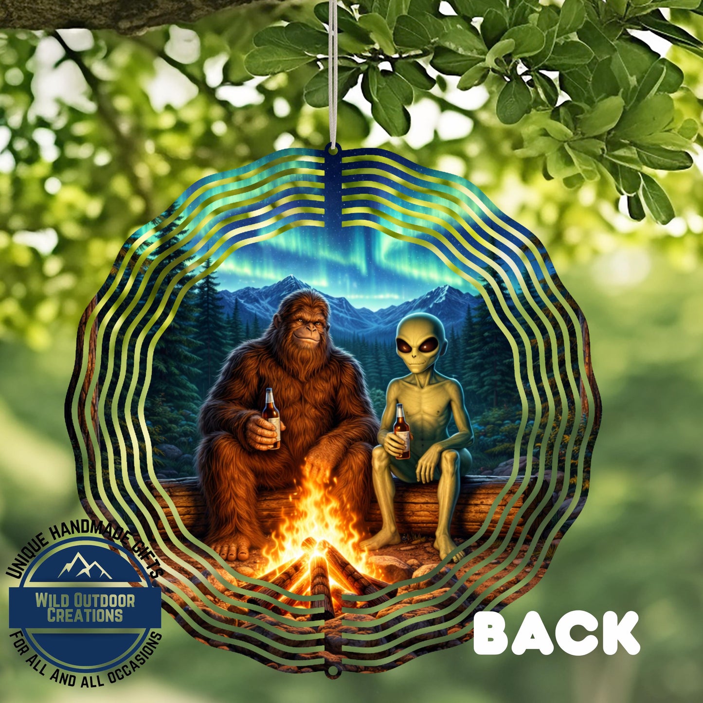 A large, circular ornament with a forest scene inside, featuring a large, furry creature and a smaller alien-like creature sitting by a campfire.