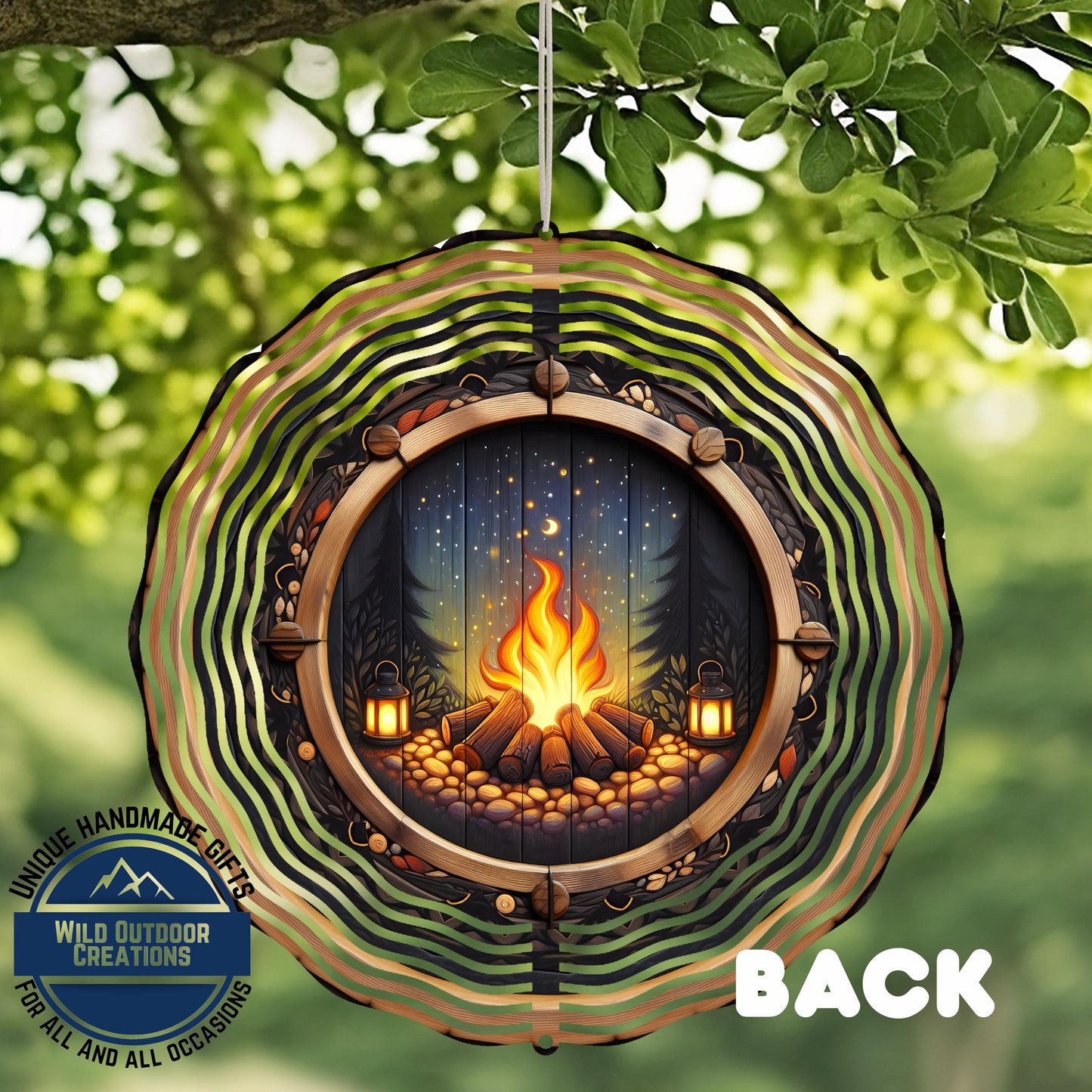 A decorative wind chime with a fire pit design, featuring a fire burning in a wooded area with a starry night sky.