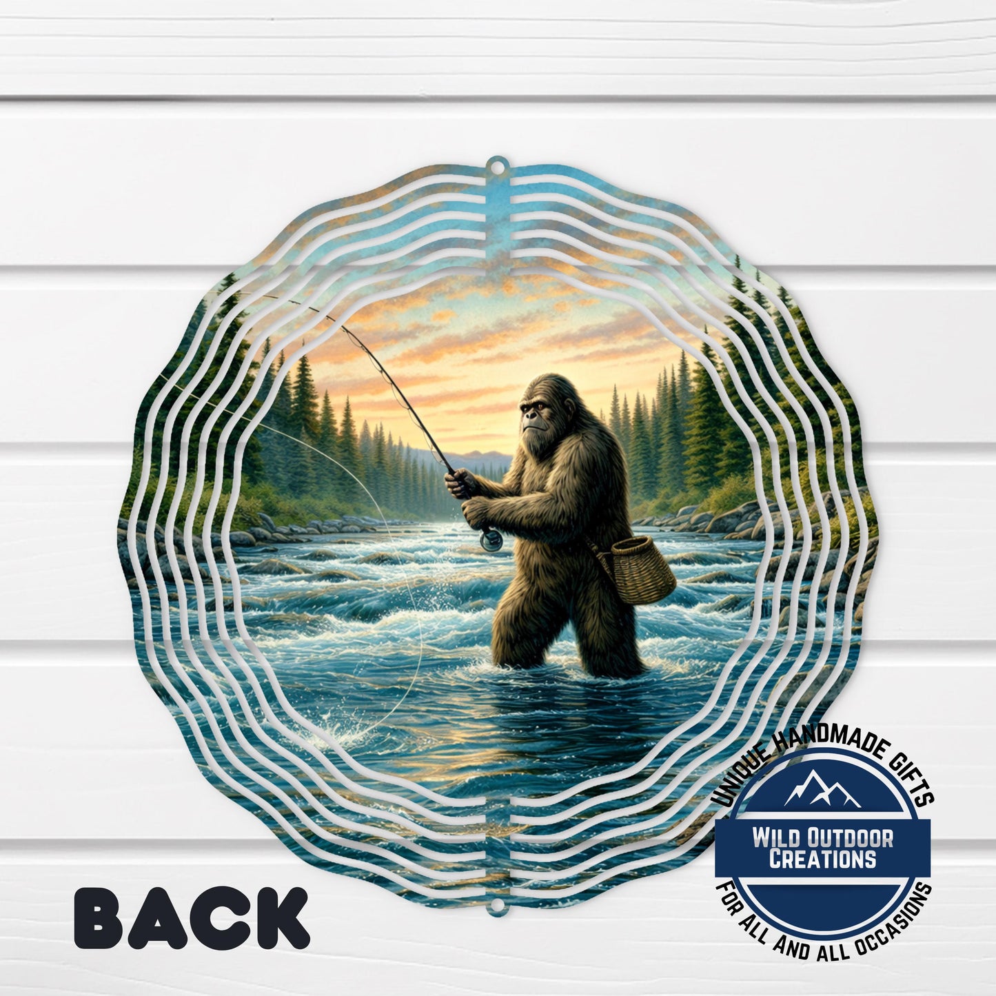 A large, circular metal decoration featuring a depiction of a giant, furry creature standing in a river, holding a fishing rod and surrounded by a forest landscape.