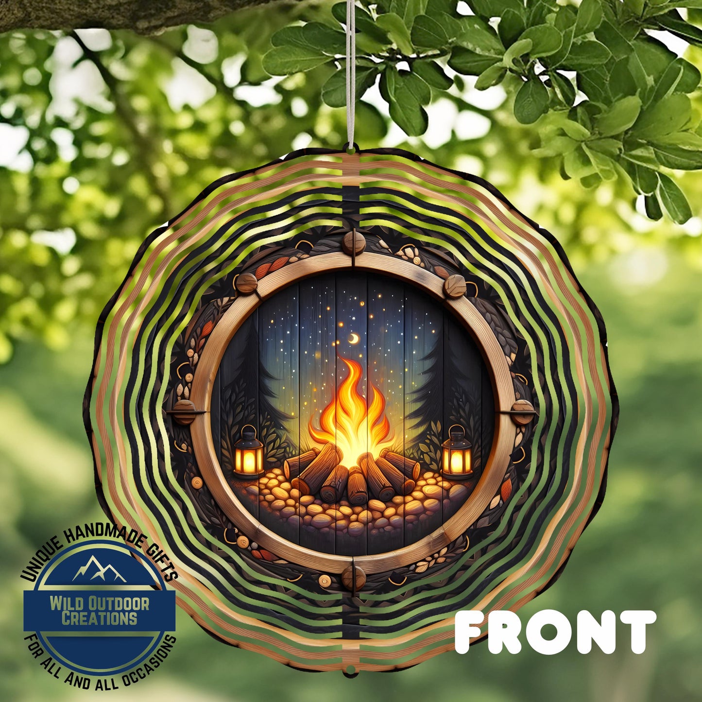 A decorative wind chime with a fire pit design, featuring a fire burning in a wooded area with a starry night sky.
