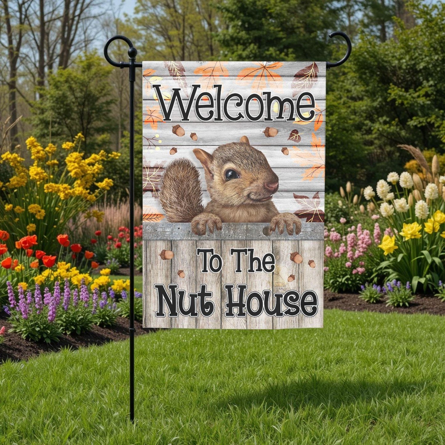 A garden sign with a squirrel on it, surrounded by colorful flowers and greenery.