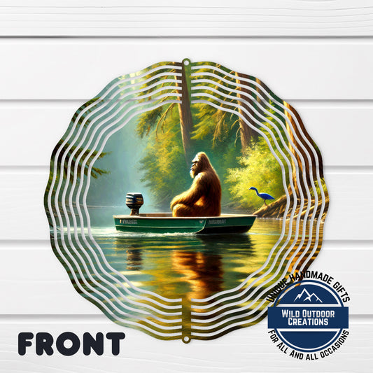 A large metal wind chime with a painting of a brown gorilla sitting in a boat on a river, surrounded by trees and a blue bird.